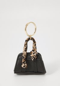 Black leather handbag with textured finish, featuring a gold circular handle and a tan and black leopard print scarf tied around the handle.