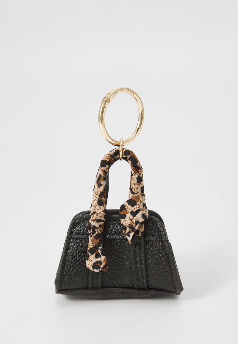 Black leather handbag with textured finish, featuring a gold circular handle and a tan and black leopard print scarf tied around the handle.