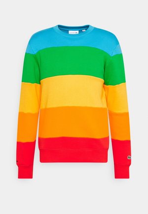 Rondehals trui met horizontale strepen in blauw, groen, geel, oranje en rood, met een klein Lacoste-logo op de linkermouwboord.