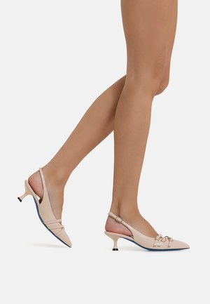 Beige slingback heels with a pointed toe, featuring multiple side straps, a small heel, and black-and-blue accents.