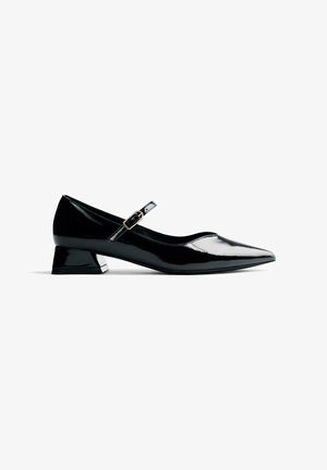 Escarpin en cuir verni noir avec un bout pointu, une bride de cheville et un talon bloc modeste, présentant une finition brillante et de subtils accents métalliques.