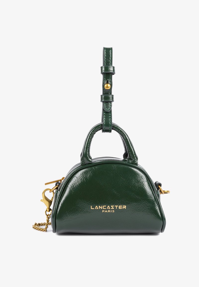 Green leather handbag with a rounded shape, double top handles, a removable strap, gold-tone hardware, and embossed logo on the front.