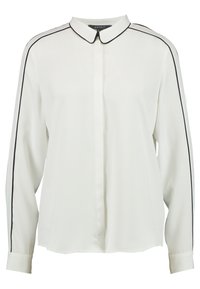 Blusa bianca con maniche lunghe, piping nero lungo le maniche e il colletto, bottoni frontali nascosti e colletto a punta.
