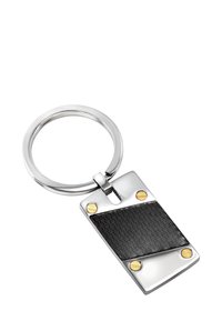 Hopeinen avaimenperä suorakulmaisella rungolla, jossa on teksturoitu musta keskiosa ja kultaiset koristeet kulmissa. Sileä, kiillotettu pinta.