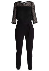 Zwarte jumpsuit met een doorschijnende top met stippen, driekwart mouwen en een aangesloten taille. Heeft een strikceintuur en een tapered leg ontwerp.