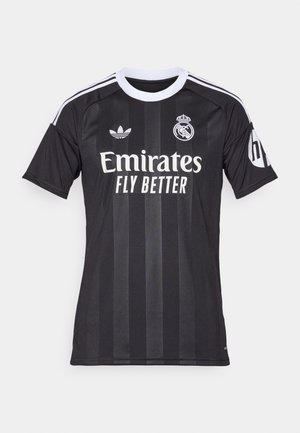 Maglia da calcio nera del Real Madrid con colletto bianco, loghi Adidas e della squadra, testo dello sponsor Emirates Fly Better e logo HP sulla manica.