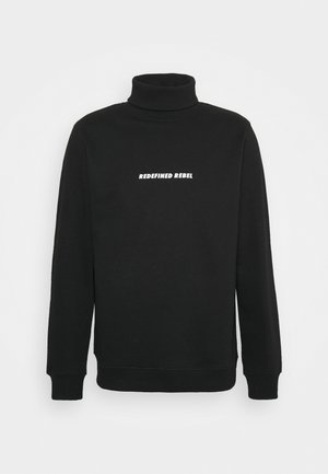 Zwarte coltrui met lange mouwen en witte tekst "REDEFINED REBEL" gecentreerd op de borst tegen een effen achtergrond.