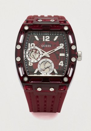 Relógio acrílico vermelho com mostrador quadrado, três submostradores e detalhes em metal prateado. A bracelete texturizada melhora a aderência e o conforto.