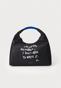 Black fabric handbag with a blue handle, featuring white text that reads “I’M LIVING MY MEMOIR, I DON’T NEED TO WRITE IT. KL.”