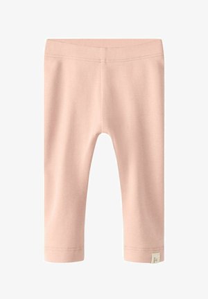 Vaaleanpunaiset leggingsit, joissa on sileä pinta, nilkkapituus ja tikattu vyötärönauha. Sivussa on pieni lappu.