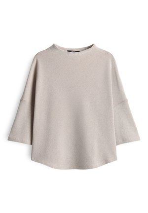 Blusa a righe beige e bianca con maniche lunghe, larghe e fit rilassato, esposta su uno sfondo bianco.