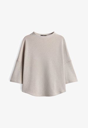 Blusa a righe beige e bianca con maniche lunghe, larghe e fit rilassato, esposta su uno sfondo bianco.