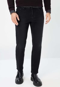BRAX STYLE CHUCK TT - Straight leg jeans - black used