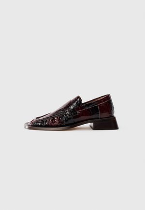 Dark burgundy patent leather loafer with textured finish, low block heel, and classic penny strap detailing, shown from the side.