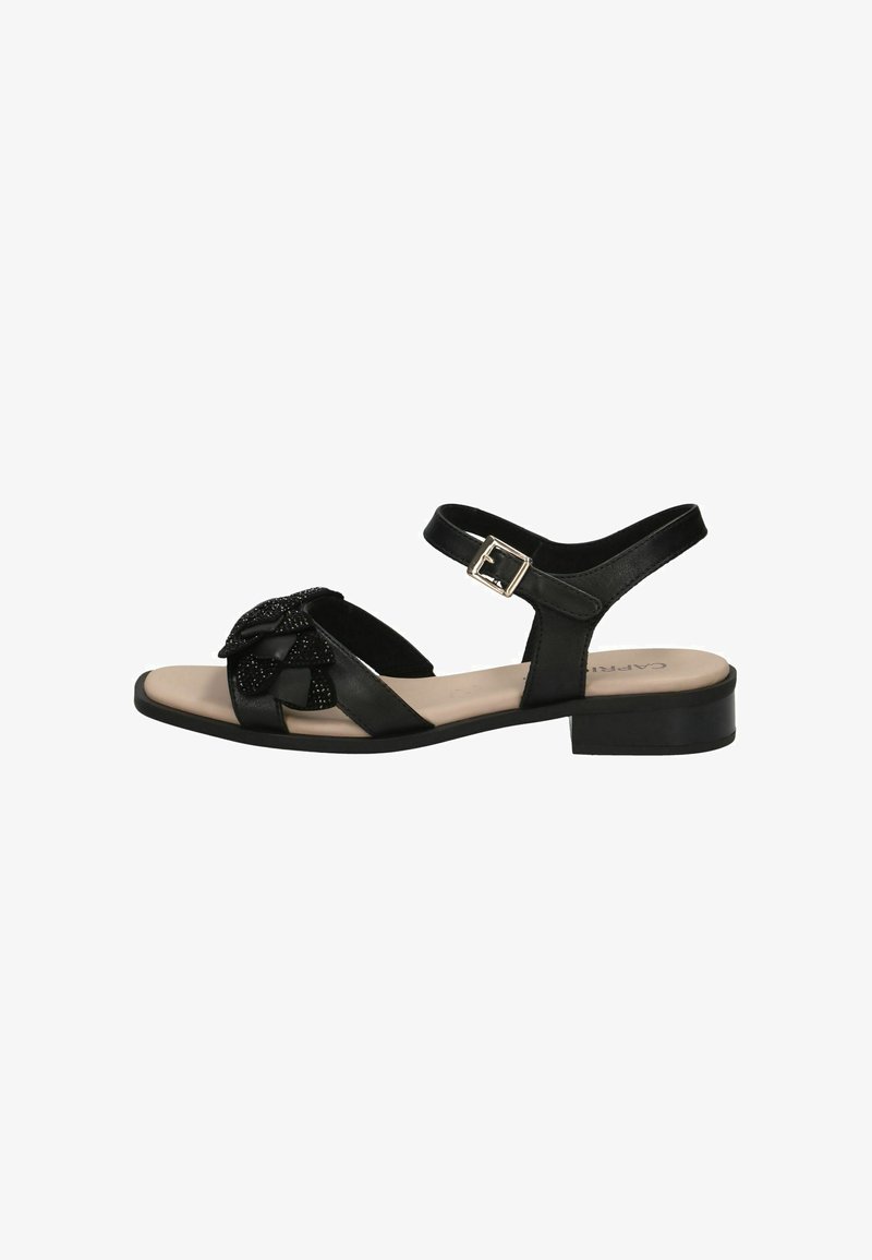 Sandale noire à petit talon, avec un nœud texturé orné de perles et une bride réglable avec une boucle argentée. Matière en cuir lisse.
