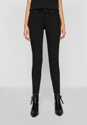 Black skinny jeans with a slim fit, featuring a classic five-pocket design, metal hardware, and a smooth, stretchy cotton blend fabric.