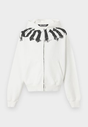 Witte hoodie met rits met een zwarte verweerde "Palm"-tekst over de bovenborst en schouders, voorzakken en een capuchon.