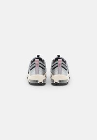 Black and gray athletic shoes with a streamlined design, featuring a visible air cushioning unit and textured fabric details. Pink accents on the heel.