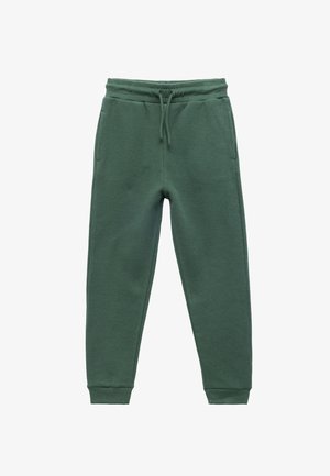Grüne Sweatpants aus Waffelstrick mit elastischem Bund, Kordelzug und Seitentaschen. Mit tapered Beinen und enganliegenden Bündchen.