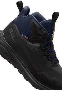 Schwarzer Wanderschuh mit strukturierter Oberfläche, navyfarbener Mesh-Kragen und verstärkter Zehenkappe. Verfügt über ein Schnürdesign und eine strukturierte Gummisohle für besseren Halt.