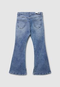 Jeans in denim blu a zampa di elefante con vita media, design con yoke sul retro e due tasche posteriori. Presentano un orlo sfilacciato e una consistenza morbida.