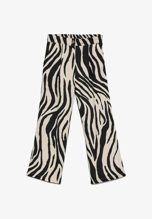 Pantalon taille haute avec rayures zèbre noires et blanches, jambes larges, fermeture par boutons et fermeture éclair dissimulée à l'avant.