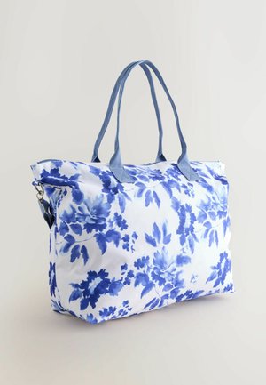 Borsa a tracolla floreale con una combinazione di colori blu e bianco, realizzata in tessuto, con manici doppi blu e chiusura con zip.