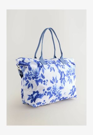 Lille lillekott, millel on sinine ja valge värvigamma, kangast konstruktsioon, kaks sinist käepidet ja lukuga sulgur.