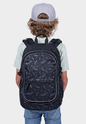 Black backpack with bat pattern, padded straps, and multiple zippers. Made of durable fabric; features a top handle and side buckles.
