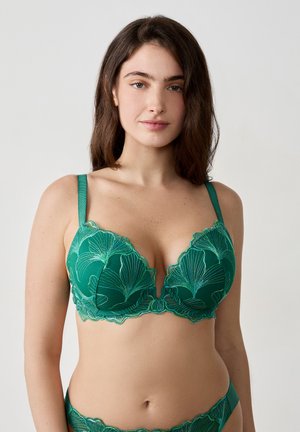 Groene bloemenkant bh met een diepe decolleté, verstelbare bandjes en gegolfde randen met ingewikkelde borduurdetails.