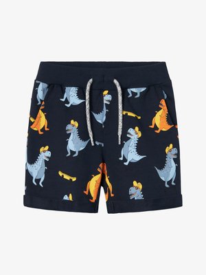 Tamno plavi šorts s uzorkom dinosaura u plavoj, narančastoj i žutoj boji, s pojasom na vezanje i prevrnutim rubovima za detalje u dizajnu.