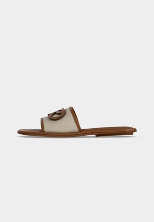 Flat slide sandal with a tan leather sole and beige fabric wide strap featuring a raised brown circular logo on top.