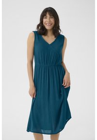 Teal sleeveless dress with a V-neck, textured fabric, fitted waist, and flowing skirt. Features scalloped trim along the neckline.