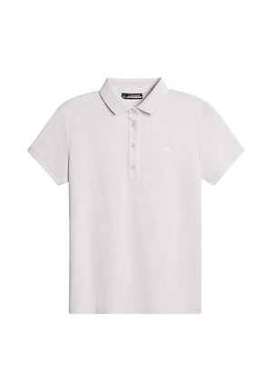 Ljusgrå polo shirt gjord av slät tyg. Har krage, tre knappar, korta ärmar och en liten logotyp på bröstet.