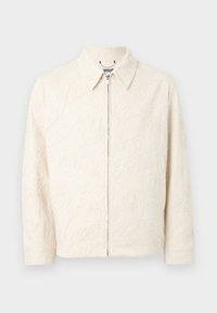 Krämfärgad jacka med krage, prydd med upphöjd blommig broderi. Den har dragkedja framtill och långa ärmar med rak skärning.