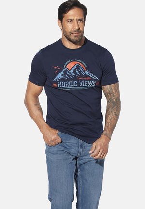Navy blue cotton t-shirt featuring mountain graphic in blue and red with "NORDIC VIEWS" text; worn with light blue jeans.