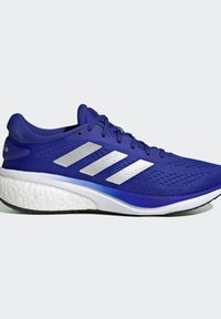 Blue athletic shoe with a textured mesh upper, featuring three silver stripes, white midsole, and black rubber outsole.