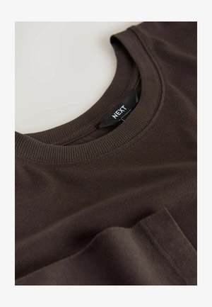Brown cotton T-shirt with a crew neck and ribbed texture. Label reads "NEXT," located on the inside neck area. Flat lay positioning.