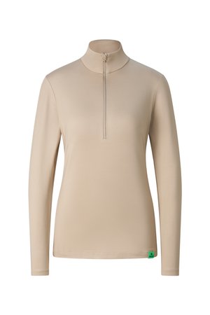 Beige long-sleeve shirt with a high collar and front zipper, fitted style, featuring a small green tag at the bottom hem.