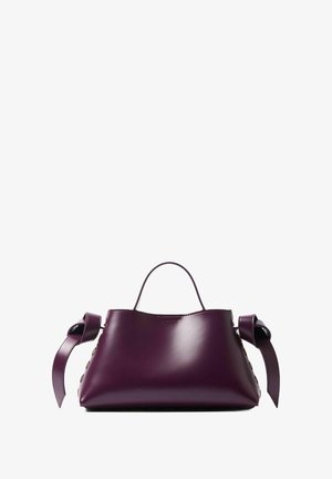 Purple leather handbag with a structured shape, featuring side ribbon accents and smooth texture. Small handle on top for carrying.