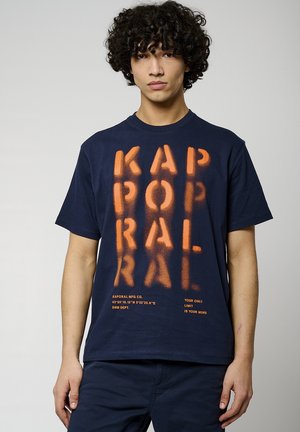 T-shirt en coton bleu marine avec du texte sprayé orange. Doté d'un col rond, de manches courtes et d'une taille droite. Le texte comprend le logo de la marque et des slogans.