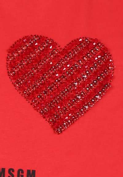 Maglietta rossa con un design a forma di cuore testurizzato realizzato con brillanti strass rossi, caratterizzata da strisce verticali e diagonali.