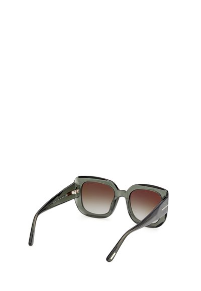 Lunettes de soleil de forme carrée avec monture translucide vert foncé et verres marron dégradés, vues sous un angle arrière.
