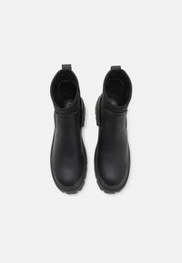 Mustad musta nahast pahkluuboot, millel on sile viimistlus, elastsed külgained ja tekstuuriga kummitaldad, mis on varustatud tõmbenööri abil lihtsaks selga panemiseks.