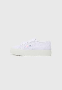 White lace sneakers with textured upper, rounded toe, and a flat rubber sole. Features a side logo and delicate floral pattern.