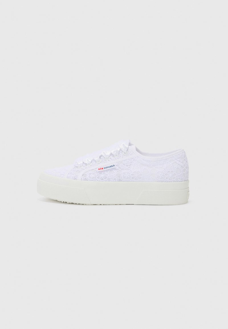 White lace sneakers with textured upper, rounded toe, and a flat rubber sole. Features a side logo and delicate floral pattern.