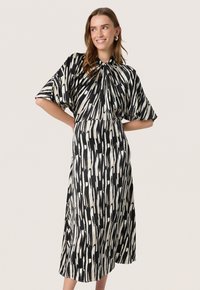 Black and white patterned dress with short, wide sleeves and a high neckline, featuring a cinched waist and flowing A-line silhouette.