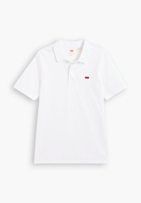 White short-sleeve polo shirt made of cotton. Features a three-button placket and a small red logo on the left chest area.