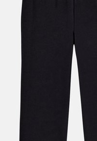 Black trousers made of soft fabric, featuring an elastic waistband, straight legs, and no visible patterns or accents.