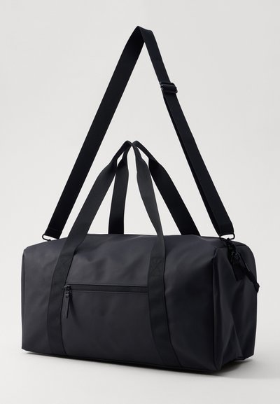 Black duffle bag made of sturdy material, featuring dual top handles, a detachable shoulder strap, and a zippered front pocket.